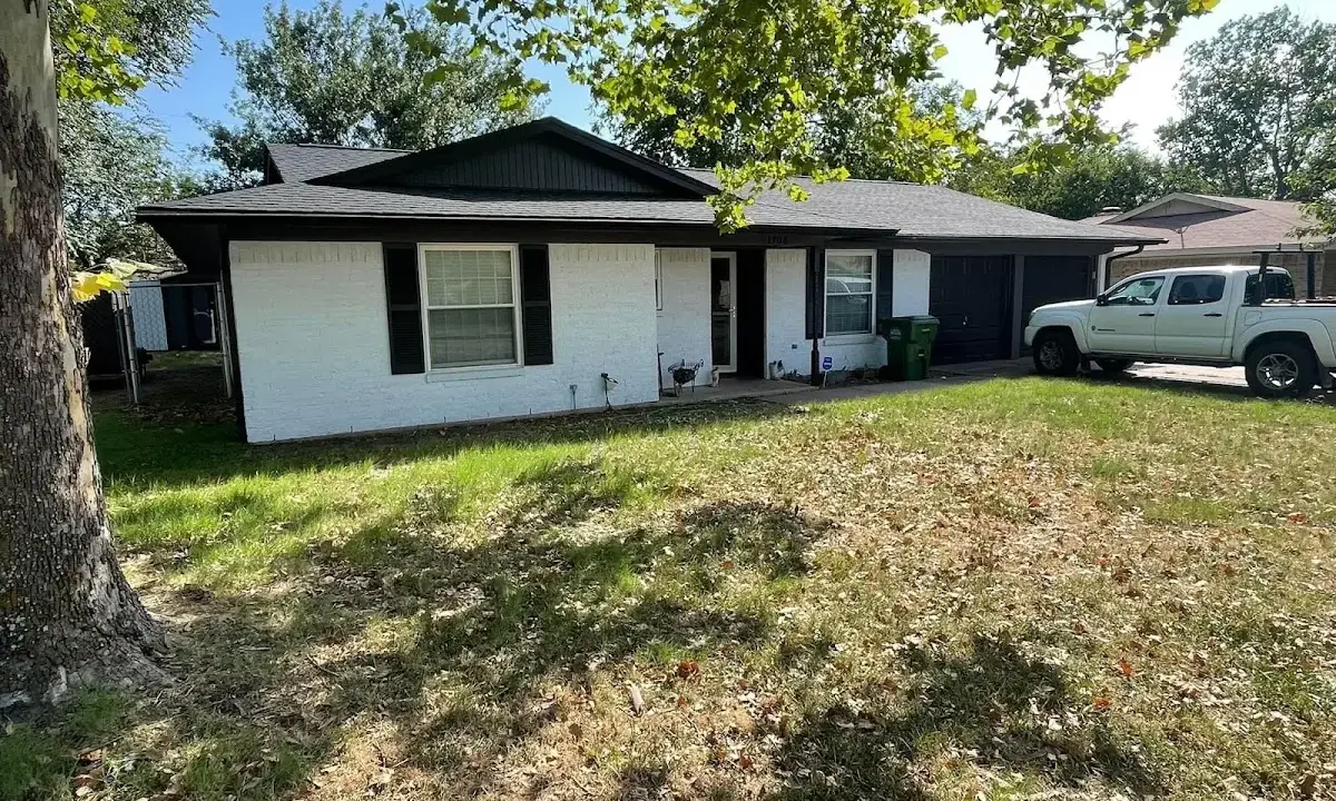 Professional roofing crew working on a residential roof in Ives Estates